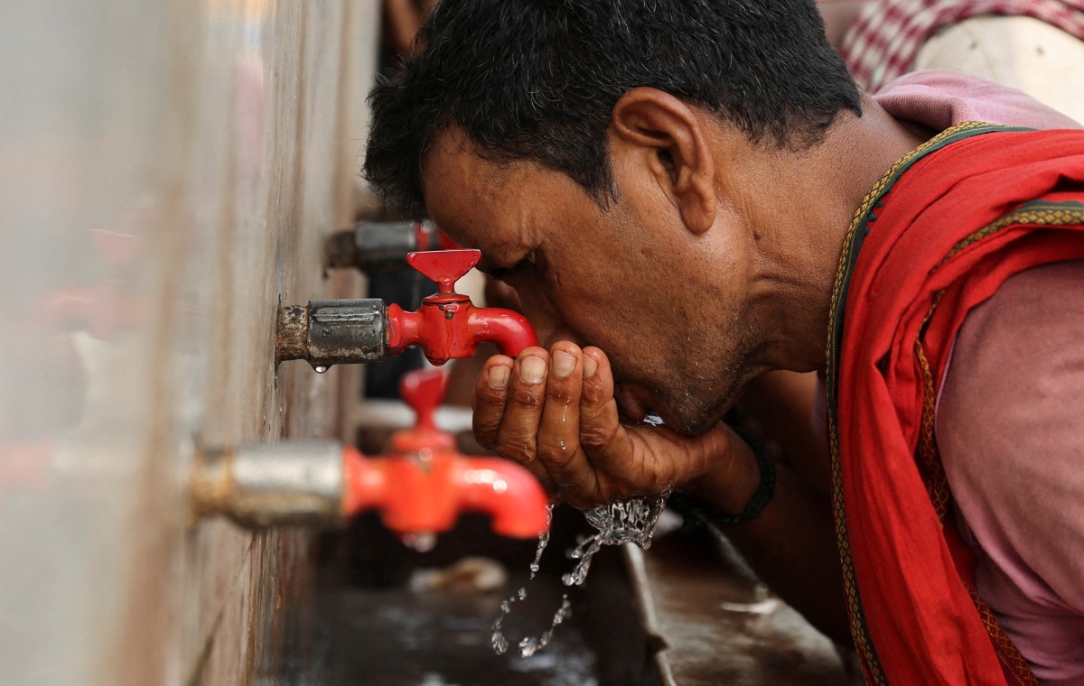 File Photo: A labourer drinks water from a public drinking water tap on a hot summer day in the old quarters of Delhi, India, May 4, 2022. (Reuters/Anushree Fadnavis)