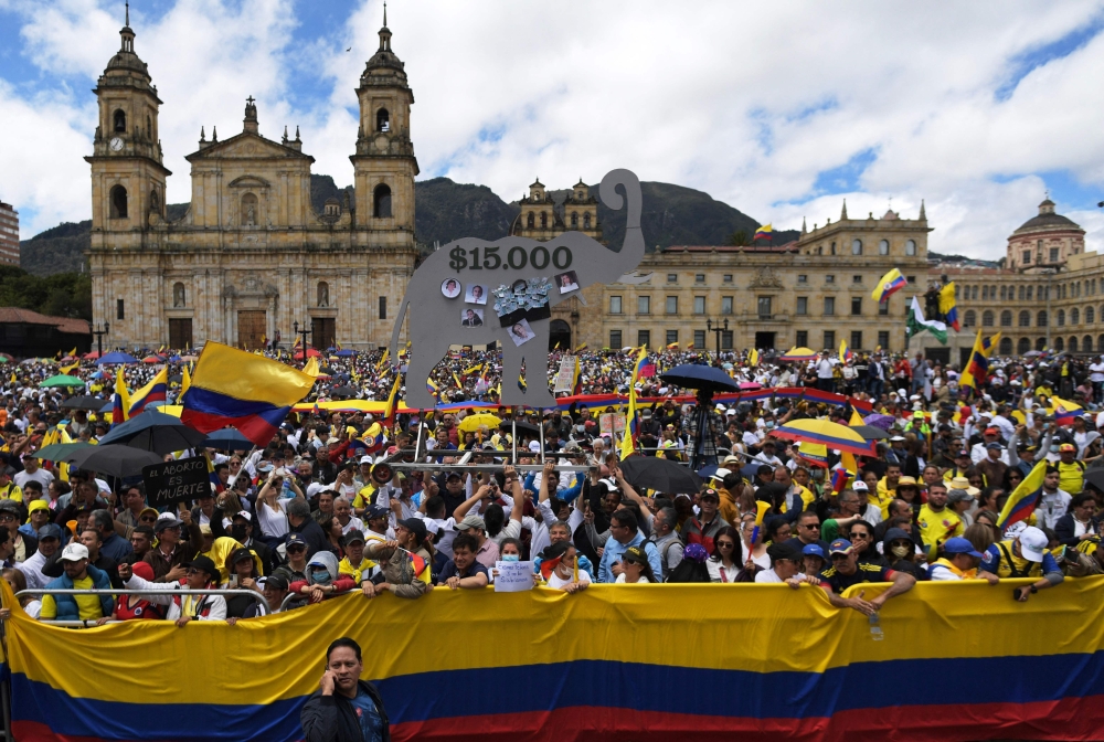 People take part in a demonstration against the Colombian President Gustavo Petro in Bogota on June 20, 2023. (Photo by Raul Arboleda / AFP)