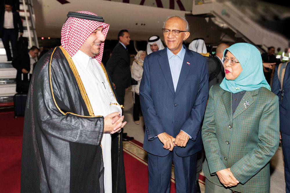 President of the Republic of Singapore H E Halimah Yacob with the Director of Protocol Department at the Ministry of Foreign Affairs H E Ibrahim bin Yousif Fakhro on her arrival at the Hamad International Airport in Doha on Monday.