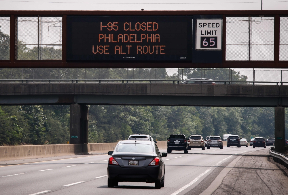 A warning sign is displayed, due to a collapsed portion of Interstate 95, caused by a large vehicle fire in Philadelphia, Pennsylvania, on the route in Lawrence Township, New Jersey, on June 11, 2023. (Photo by KENA BETANCUR / AFP)