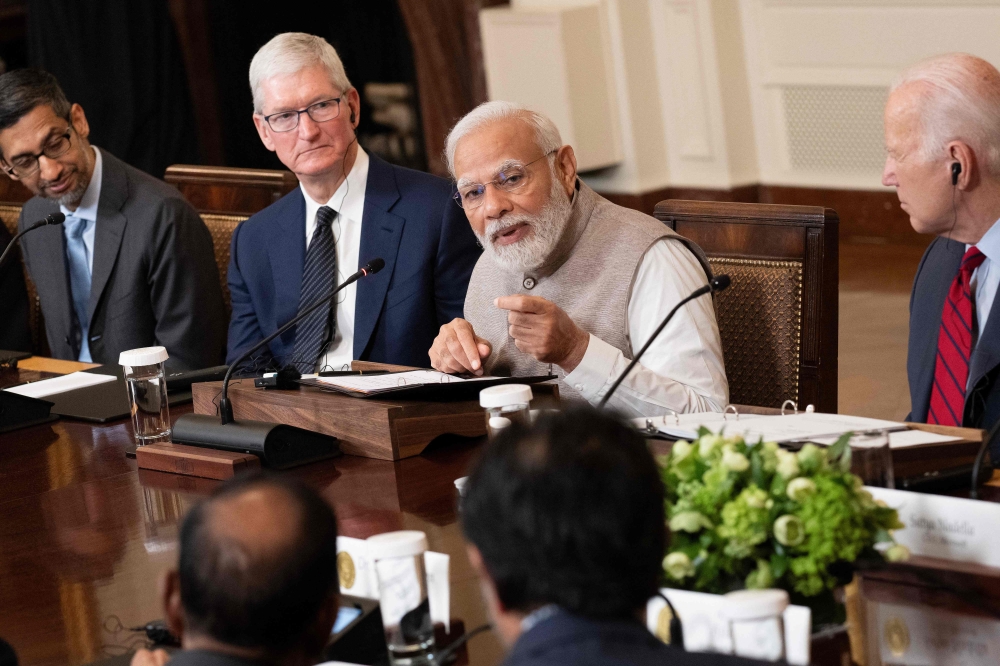 Google CEO Sundar Pichai, Apple CEO Tim Cook, and US President Joe Biden look on as India's Prime Minister Narendra Modi speaks during a meeting with senior officials and CEOs of American and Indian companies, in the East Room the White House in Washington, DC, on June 23, 2023. (Photo by Brendan Smialowski / AFP)