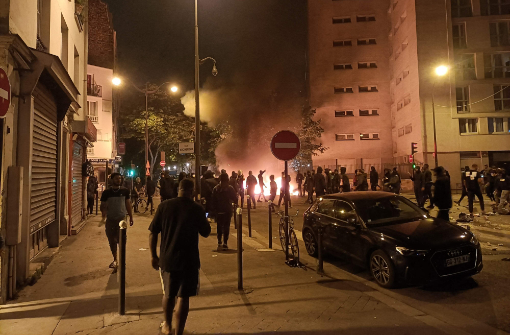People burn rubish bins and block a street during a protest in Paris on June 29, 2023, a day after the killing of 17-year-old boy, named only as Nahel M., in Nanterre by a police officer. (Photo by Fiachra GIBBONS / AFP)