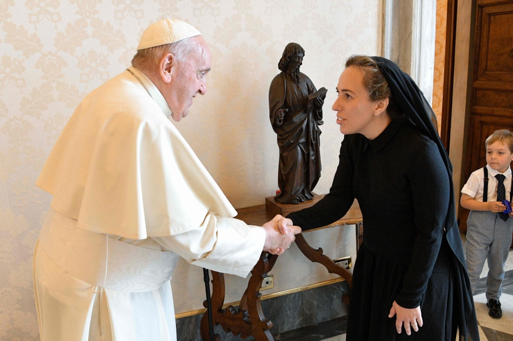 This handout photo taken and released on 30 June 2023, by The Vatican Media shows Pope Francis (L) shaking hands with Stella Assange, wife of WikiLeaks founder Julian Assange, during a private audience in the Vatican. (Photo by Handout / VATICAN MEDIA / AFP)