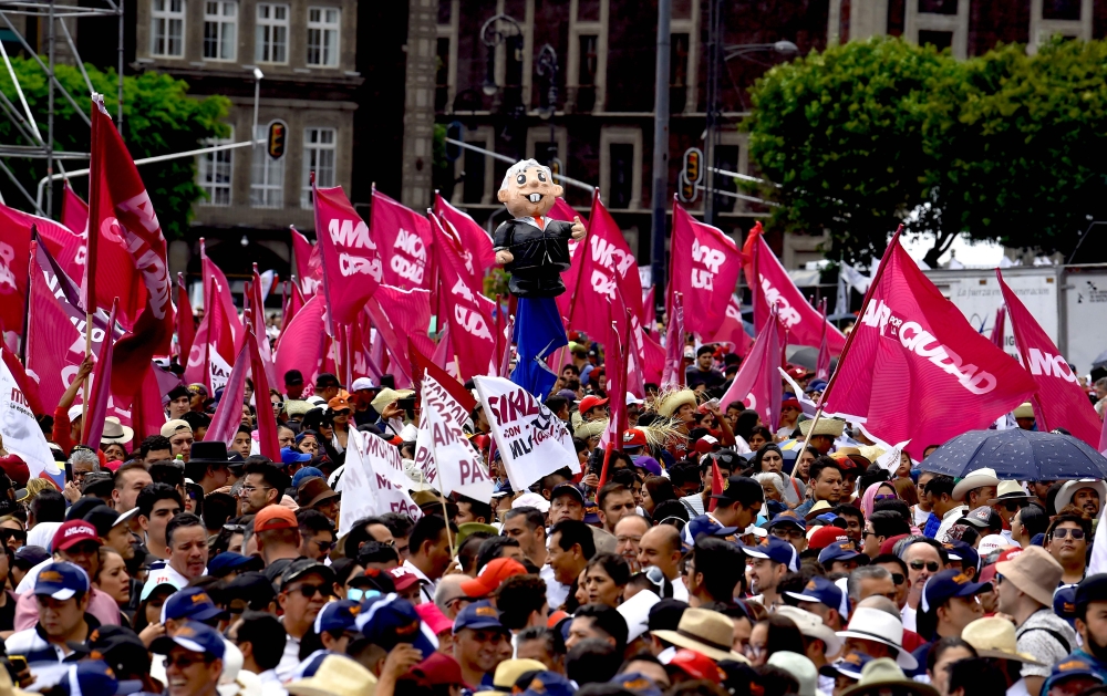 Supporters of Mexican President Andres Manuel Lopez Obrador participate in a rally to commemorate the fifth anniversary of his 2018 presidential election victory at the Zocalo (main square) in Mexico City on July 1, 2023. (Photo by CLAUDIO CRUZ / AFP)
