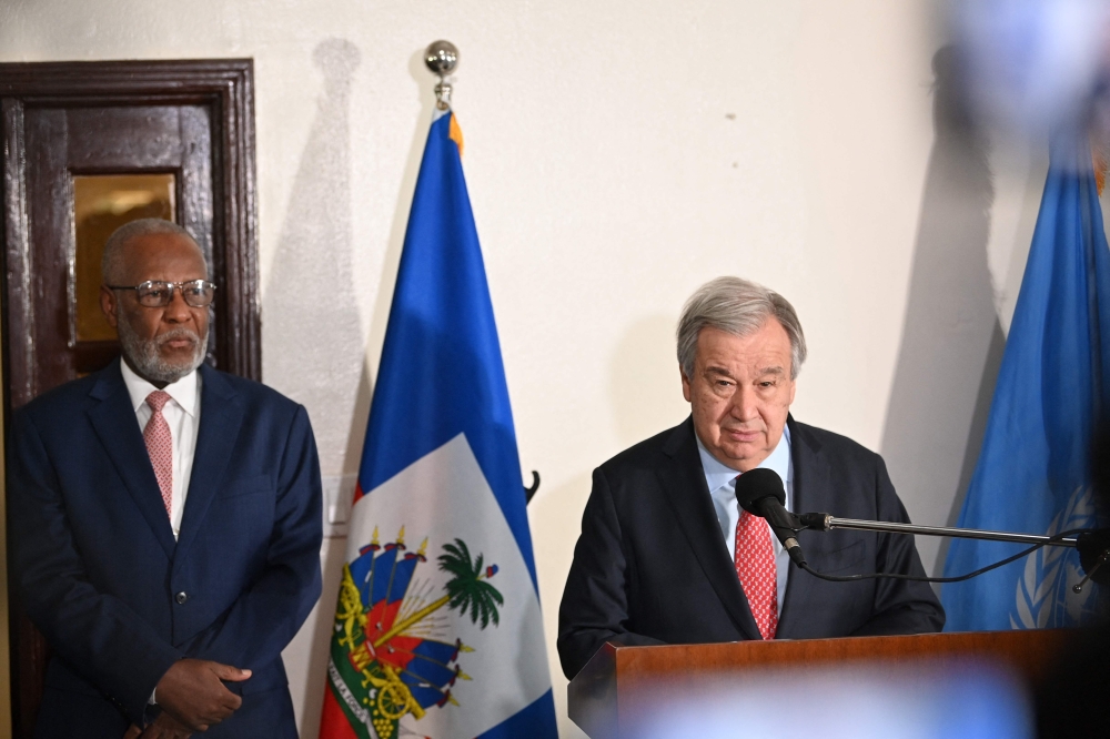 Jean Victor Geneus, Haiti's Minister of Foreign Affairs, looks on as UN Secretary-General Antonio Guterres speaks during a press conference in Port-au-Prince on July 1, 2023. (Photo by Richard Pierrin / AFP)