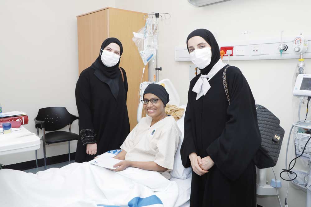 Qatar Cancer Society representatives with a cancer survivor. 