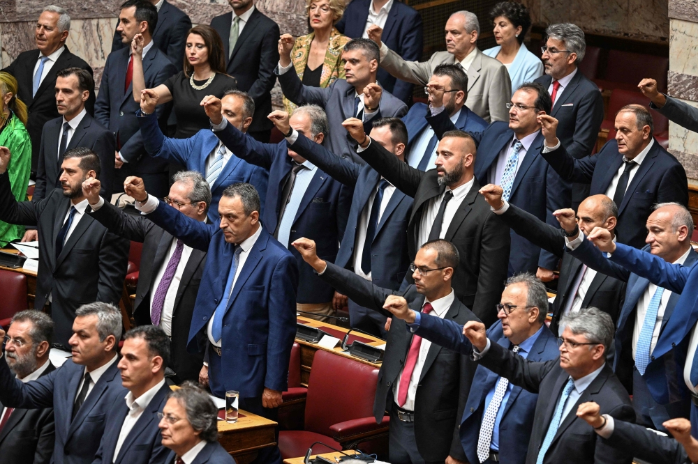 Members of Greek nationalist party Spartiates and Greek far-right party Niki (Victory) attend a swear in ceremony of the parliament in Athens on July 3, 2023, following the general elections. Greek parliament convened for its first session after the June 25 on July 3, 2023. (Photo by Aris MESSINIS / AFP)
