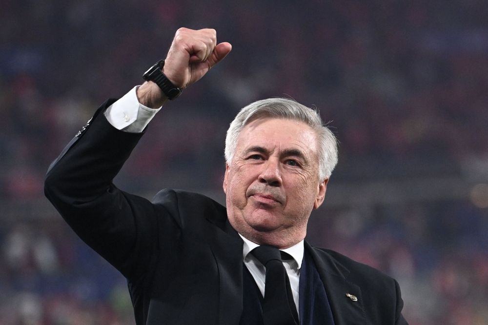 (FILES) Real Madrid's Italian coach Carlo Ancelotti gestures as he celebrates his team's victory during the UEFA Champions League final football match between Liverpool and Real Madrid at the Stade de France in Saint-Denis, north of Paris, on May 28, 2022. (Photo by Anne-Christine POUJOULAT / AFP)
