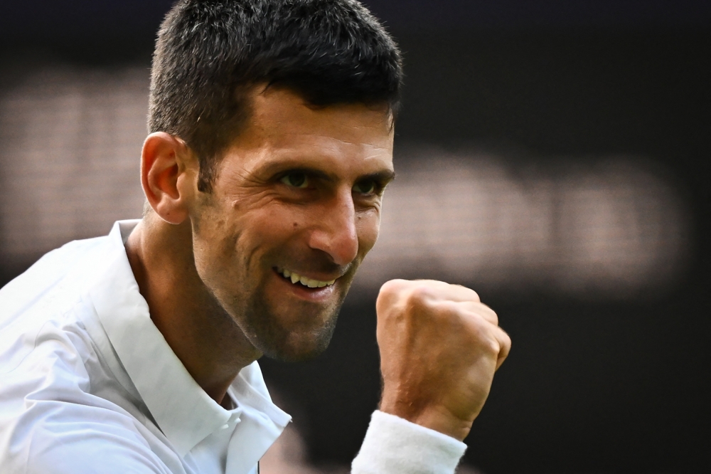 Serbia's Novak Djokovic celebrates after winning against Australia's Jordan Thompson during their men's singles tennis match on the third day of the 2023 Wimbledon Championships at The All England Tennis Club in Wimbledon, southwest London, on July 5, 2023. (Photo by SEBASTIEN BOZON / AFP) 

