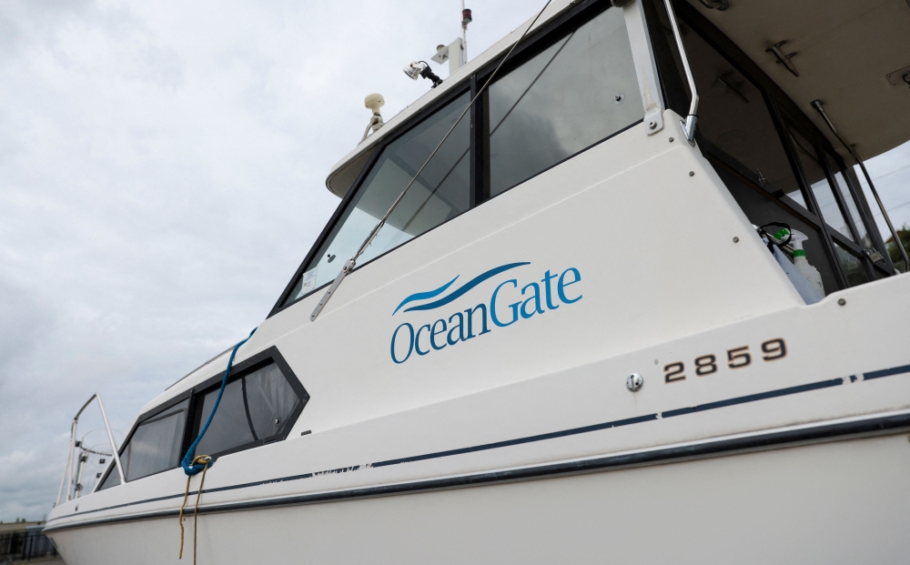 File Photo: The OceanGate logo is pictured on a boat at the Port of Everett Boat Yard in Everett, Washington, on June 20, 2023. (Photo by Jason Redmond / AFP)