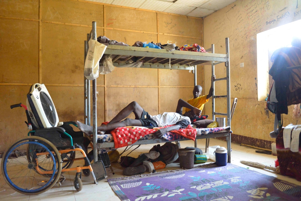 Displaced people who fled the ongoing violence by two rival Sudanese generals, sit in a room inside the university of al-Jazira, transformed into a makeshift shelter, in al-Hasaheisa south of Khartoum on July 8,2023. (Photo by AFP)
