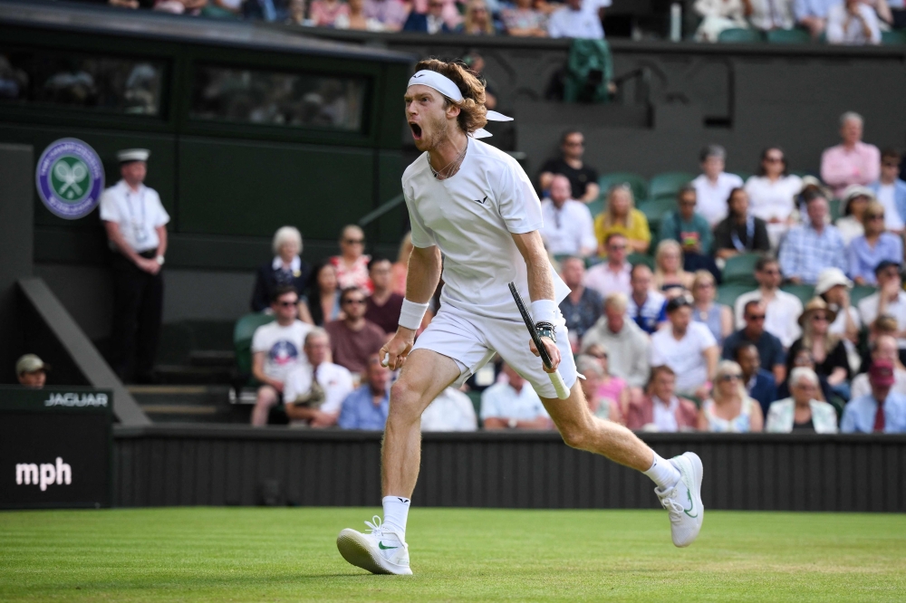 Russia's Andrey Rublev celebrates winning a point against Kazakhstan's Alexander Bublik during their men's singles tennis match on the seventh day of the 2023 Wimbledon Championships at The All England Tennis Club in Wimbledon, southwest London, on July 9, 2023. (Photo by Daniel LEAL / AFP)