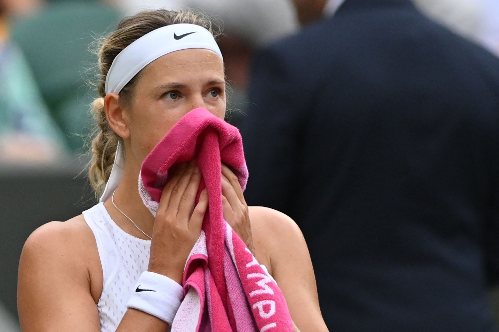 Belarus' Victoria Azarenka uses a towel during a break in play against Ukraine's Elina Svitolina during their women's singles tennis match on the seventh day of the 2023 Wimbledon Championships at The All England Tennis Club in Wimbledon, southwest London, on July 9, 2023. Photo by Glyn KIRK / AFP