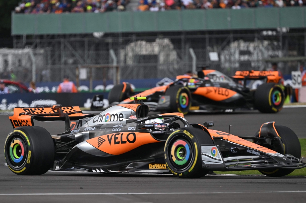 McLaren's British driver Lando Norris and McLaren's Australian driver Oscar Piastri drive during the Formula One British Grand Prix at the Silverstone motor racing circuit in Silverstone, central England on July 9, 2023. Photo by ANDREJ ISAKOVIC / AFP