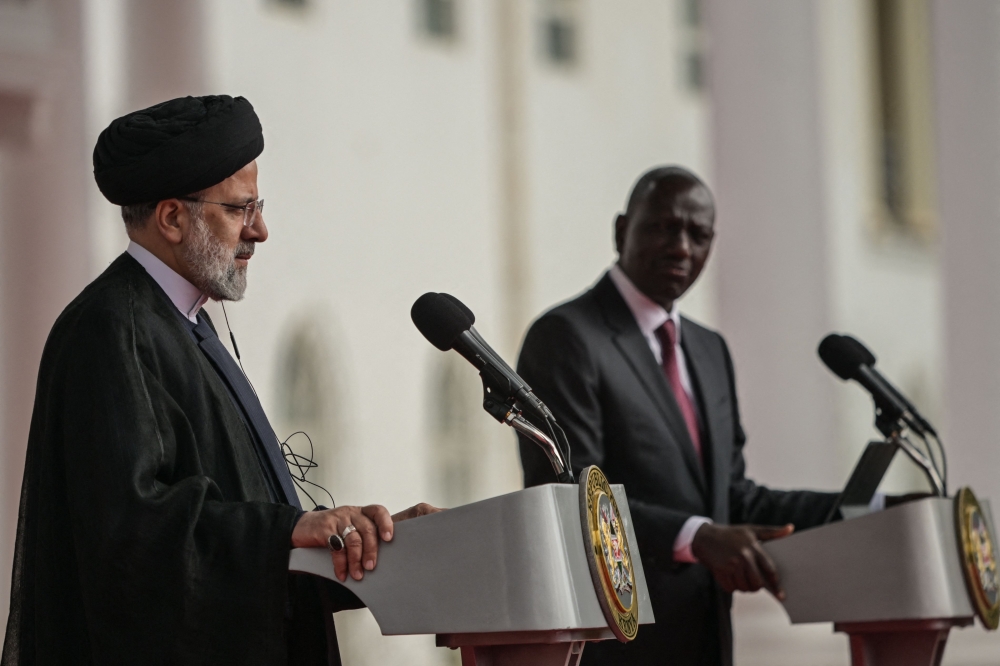 Iranian President Ebrahim Raisi (L) attends a press conference alongside Kenyan President William Ruto (R) at the State House in Nairobi on July 12, 2023. (Photo by SIMON MAINA / AFP)