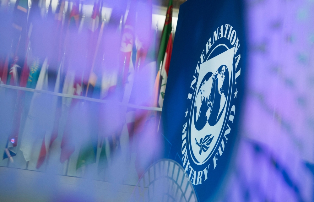 The International Monetary Fund (IMF) logo is displayed inside its headquarters in Washington, DC, on October 10, 2017. (Photo by Andrew Caballero-Reynolds / AFP)