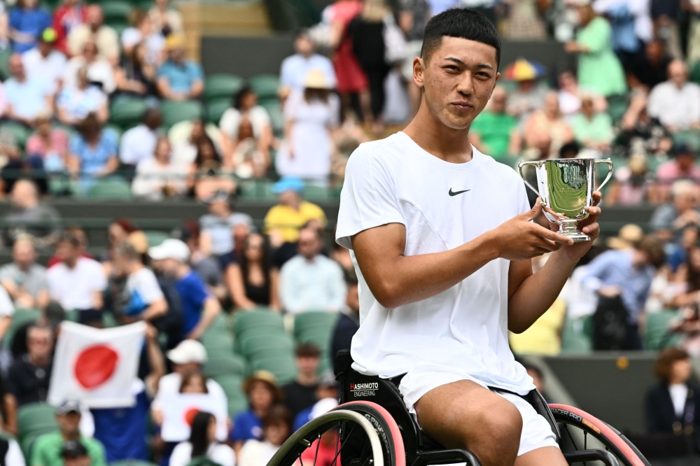 Japan's Tokito Oda holds his trophy after beating Britain's Alfie Hewett during their men's wheelchair singles final tennis match on the last day of the 2023 Wimbledon Championships at The All England Tennis Club in Wimbledon, southwest London, on July 16, 2023. Photo by SEBASTIEN BOZON / AFP