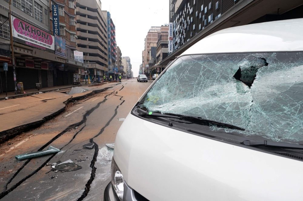 A general view of a damaged road in Johannesburg on July 20, 2023, following an unexplained explosion which occurred during rush hour on July 19, 2023. (Photo by Luca Sola / AFP)