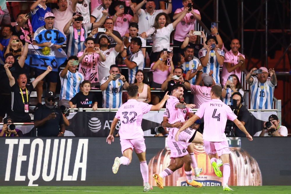 Lionel Messi #10 of Inter Miami CF celebrates with teammates after kicking the game winning goal during the second half of the Leagues Cup 2023 match between Cruz Azul and Inter Miami CF at DRV PNK Stadium on July 21, 2023 in Fort Lauderdale, Florida. Hector Vivas/Getty Images/AFP 
