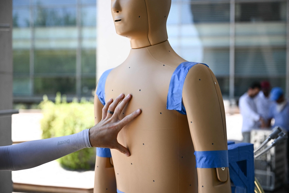 Associate Professor Konrad Rykaczewski points to the pores on ANDI, an Advanced Newton Dynamic Instrument, that bead sweat like humans as researchers prepare a heat and wind experiment to learn more about the effect of heat exposure on the human body at Arizona State University (ASU) during a record heat wave in Phoenix, Arizona, on July 20, 2023. (Photo by Patrick T. Fallon / AFP)
