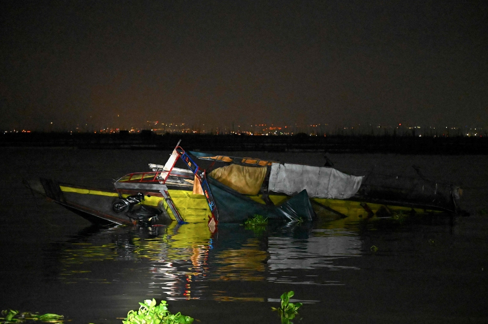 This photo shows a capsized wooden boat at Kalinawan Port Binangonan, Rizal province on July 27, 2023. Photo by JAM STA ROSA / AFP