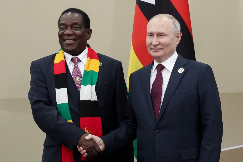 Russian President Vladimir Putin meets with his Zimbabwe counterpart Emmerson Mnangagwa during the second Russia-Africa summit in Saint Petersburg on July 27, 2023. (Photo by Vyacheslav PROKOFYEV / TASS Host Photo Agency / AFP)