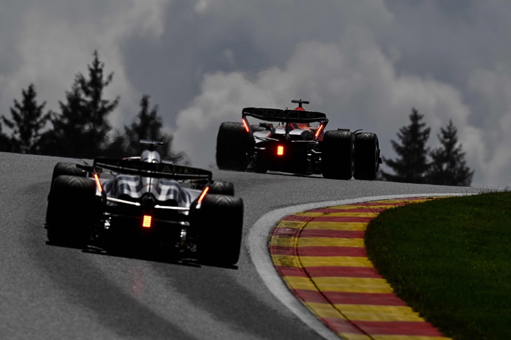 Red Bull Racing's Dutch driver Max Verstappen (R) and Alpha Tauri's Japanese driver Yuki Tsunoda compete during the sprint shootout ahead of the Formula One Belgian Grand Prix at the Spa-Francorchamps Circuit in Spa on July 29, 2023. (Photo by John Thys / AFP)