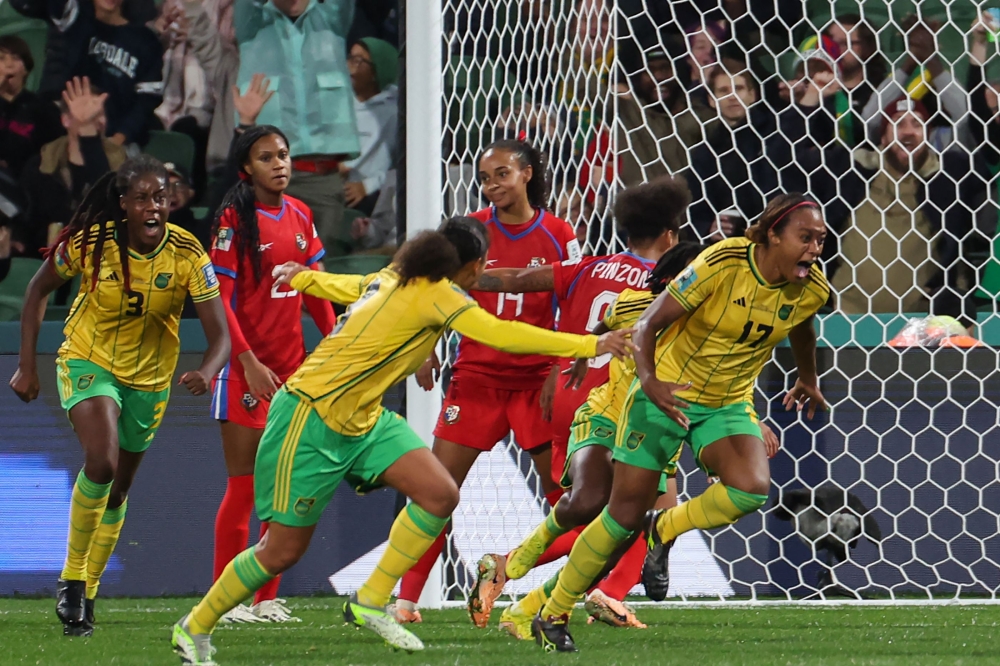 Jamaica's defender #17 Allyson Swaby (R) celebrates scoring her team's first goal during the Australia and New Zealand 2023 Women's World Cup Group F football match between Panama and Jamaica at Perth Rectangular Stadium in Perth on July 29, 2023. (Photo by Colin MURTY / AFP)
