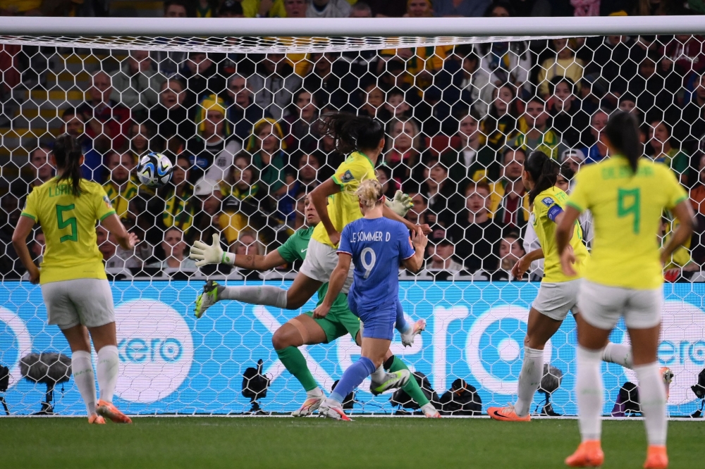 France's forward #09 Eugenie Le Sommer (C) scores her team's first goal during the Australia and New Zealand 2023 Women's World Cup Group F football match between France and Brazil at Brisbane Stadium in Brisbane on July 29, 2023. (Photo by FRANCK FIFE / AFP)
