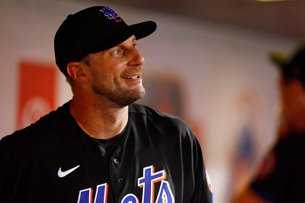 (FILES) Pitcher Max Scherzer, #21 of the New York Mets, smiles in the dugout after walking off the field in the seventh inning against the Washington Nationals at Citi Field in New York City on July 28, 2023.  (Photo by Rich Schultz / GETTY IMAGES NORTH AMERICA / AFP)
