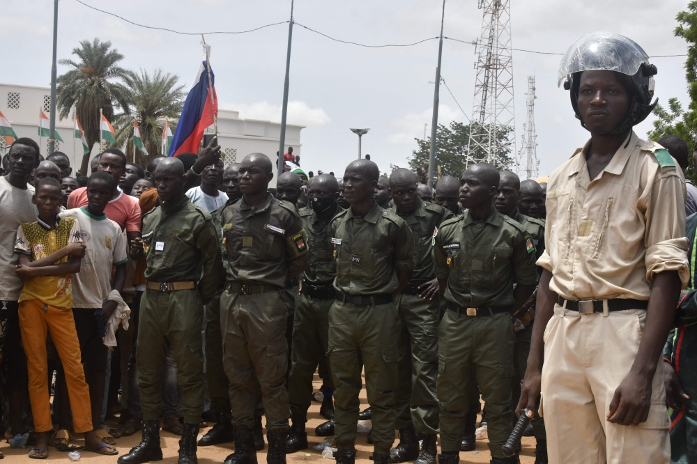 A Nigerien policeman stands as Nigerien cadets paradeas supporters rally in support of Niger's junta in Niamey on July 30, 2023. (Photo by AFP)
