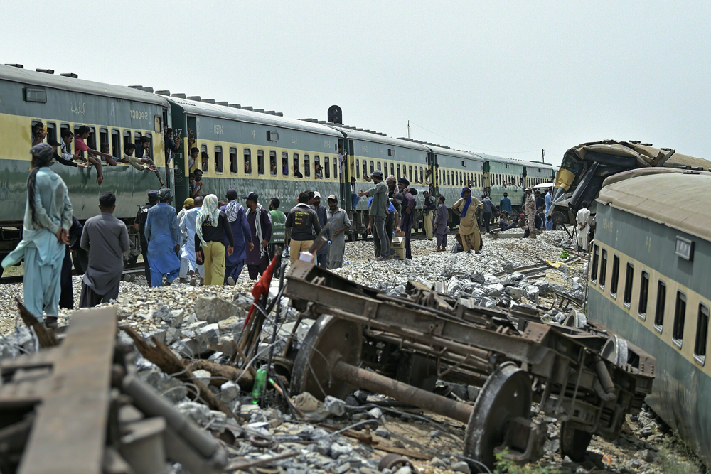 Workers repair a damaged track, a day after the derailment of a passenger train in Nawabshah on August 7, 2023. Photo by Asif HASSAN / AFP