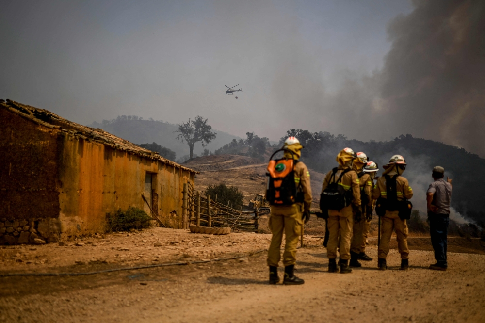 Personnel of the Protection and Relief Intervention Group (GIPS) specialised in combating forest fires, arrive to battle a wildfire in Reguengo, Portalegre district, south of Portugal, on August 8, 2023. Photo by Patricia DE MELO MOREIRA / AFP