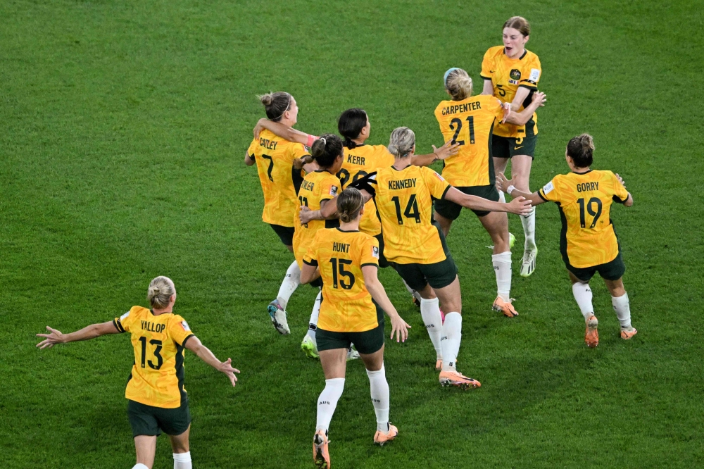 Australia's players celebrate their victory after a penalty shoot-out in Brisbane on August 12, 2023. (Photo by William West / AFP)
