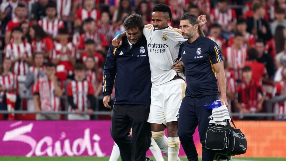 Real Madrid's Brazilian defender #03 Eder Militao is helped to leave the pitch after resulting injured during the Spanish Liga football match between Athletic Bilbao and Real Madrid at the San Mames stadium in Bilbao on August 12, 2023. (Photo by CESAR MANSO / AFP)