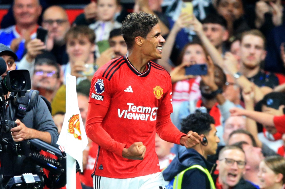 Manchester United's French defender #19 Raphael Varane celebrates scoring the opening goal during the English Premier League football match between Manchester United and Wolverhampton Wanderers at Old Trafford in Manchester, north west England, on August 14, 2023. (Photo by Lindsey Parnaby / AFP) 