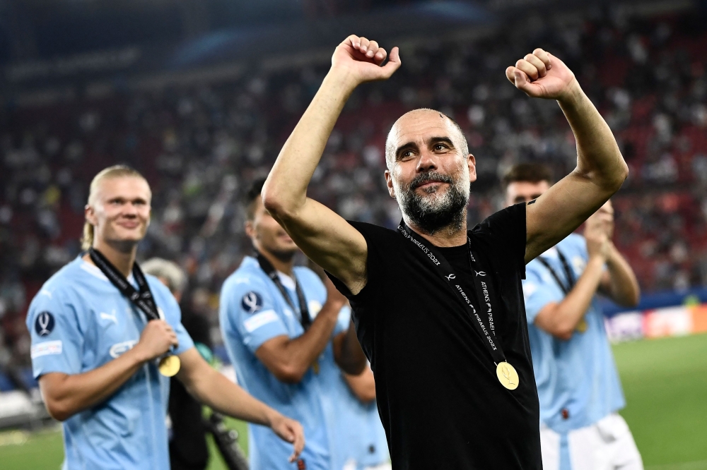 Manchester City's Spanish manager Pep Guardiola celebrates after winning the 2023 UEFA Super Cup football match between Manchester City and Sevilla at the Georgios Karaiskakis Stadium in Piraeus on August 16, 2023. Photo by Spyros BAKALIS / AFP
