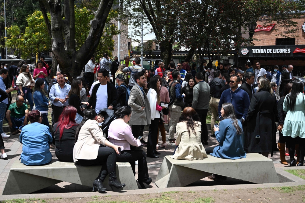 People remain on the streets after an eartquake in Bogota, on August 17, 2023.  (Photo by Raul ARBOLEDA / AFP)
