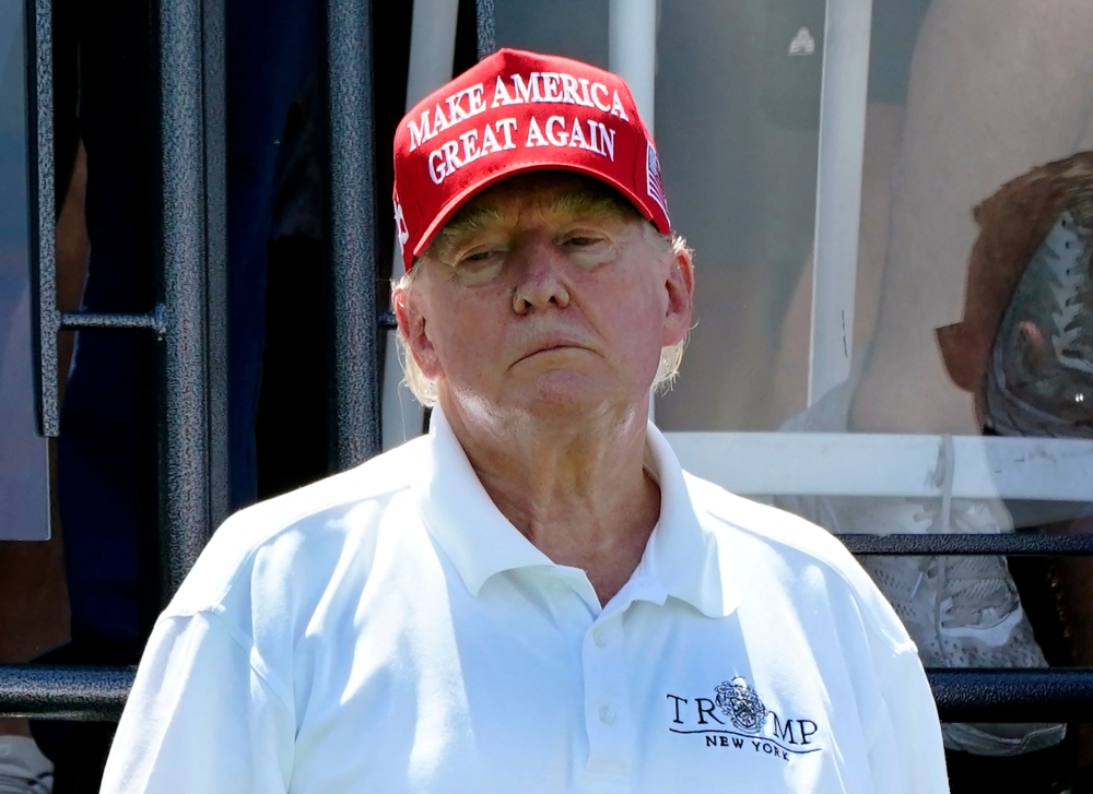 File: Former US President Donald Trump looks on during Round 3 at the LIV Golf-Bedminster 2023 at the Trump National in Bedminster, New Jersey, on August 13, 2023. (Photo by Timothy A Clary / AFP)