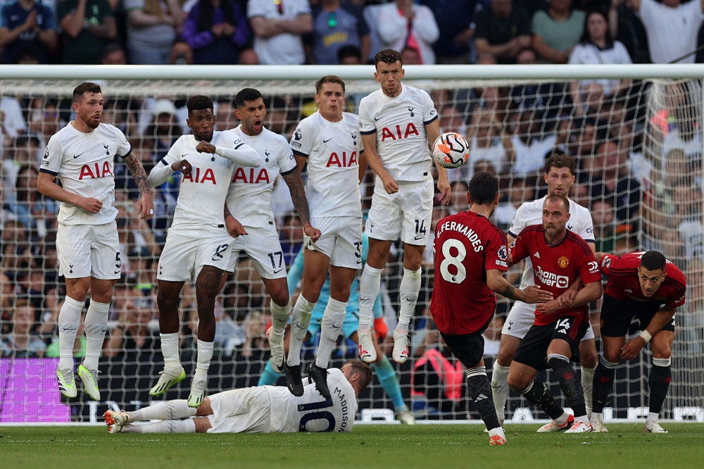 Manchester United's Portuguese midfielder #08 Bruno Fernandes takes a free kick during the English Premier League football match between Tottenham Hotspur and Manchester United at Tottenham Hotspur Stadium in London, on August 19, 2023. (Photo by Adrian DENNIS / AFP)