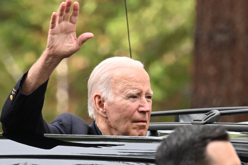 US President Joe Biden waves as he departs from Our Lady of Tahoe Catholic Church in Zephyr Cove, Nevada on August 19, 2023. Photo by Mandel NGAN / AFP