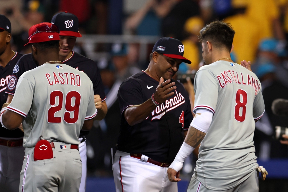 Manager Dave Martinez #4 of the Washington Nationals shakes hands with Nick Castellanos #8 of the Philadelphia Phillies following the Nationals 4-3 win during the 2023 Little League Classic at Bowman Field on August 20, 2023 in South Williamsport, Pennsylvania. (Photo by Rob Carr / GETTY IMAGES NORTH AMERICA / Getty Images via AFP)
