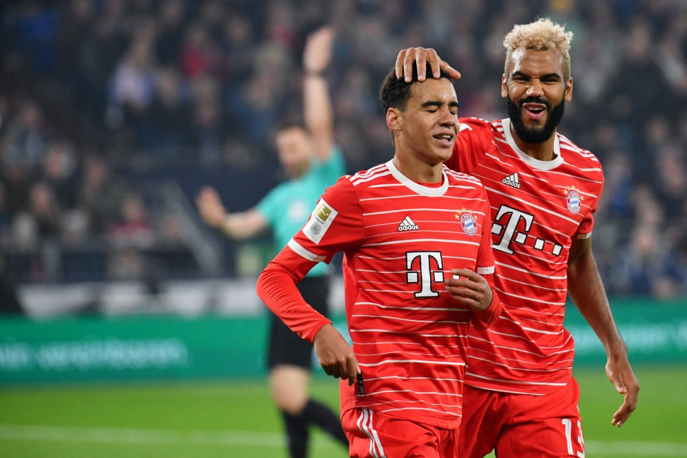 File photo: Bayern Munich's Cameroonian forward Eric Maxim Choupo-Moting (right) reacts with Bayern Munich's German midfielder Jamal Musiala during the German first division Bundesliga football match between Schalke 04 v Bayern Munich in Gelsenkirchen, Germany, on November 12, 2022. (Photo by UWE KRAFT / AFP)

