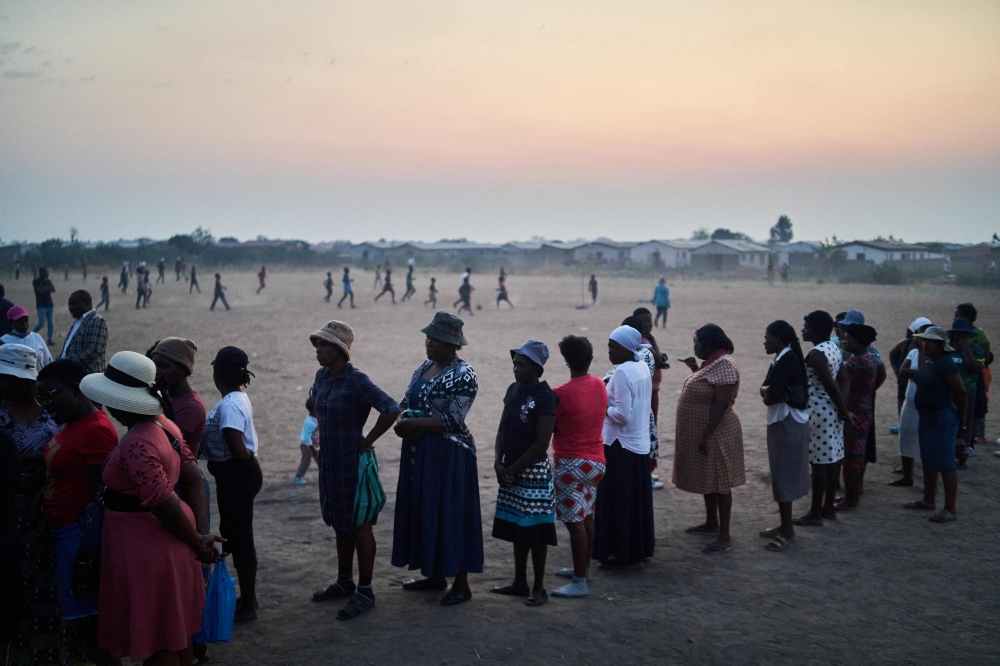 Voters queue to cast their ballots at a polling station in Bulawayo on August 23, 2023. (Photo by Zinyange Auntony / AFP)
