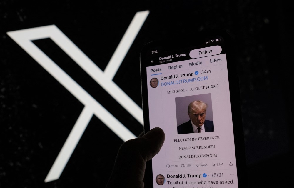 This illustration photo shows former US President Donald Trump's mugshot on X (formerly Twitter), on August 24, 2023. (Photo by Chris Delmas / AFP)