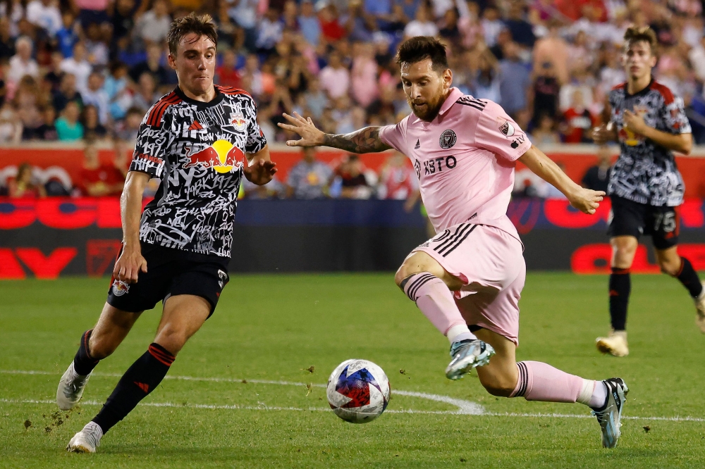 Lionel Messi #10 of Inter Miami CF battles against Peter Stroud #5 of New York Red Bulls in the second half during a match between Inter Miami CF and New York Red Bulls at Red Bull Arena on August 26, 2023 in Harrison, New Jersey.
