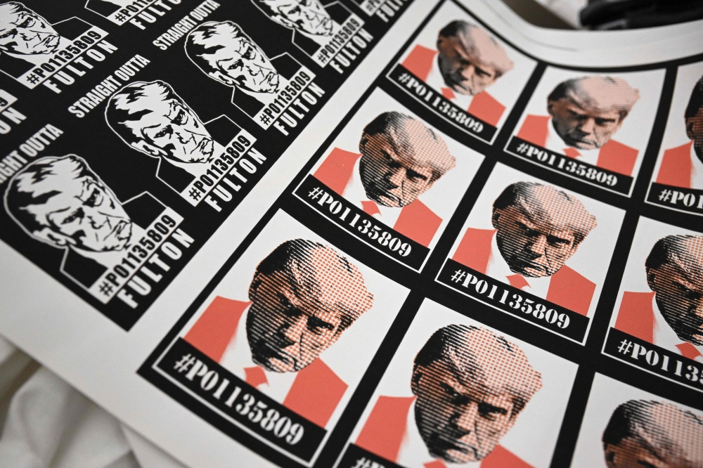 Trump stickers featuring his mug shot are displayed for sale at the Y-Que shop in Los Angeles, California on August 30, 2023. (Photo by Robyn Beck / AFP)

