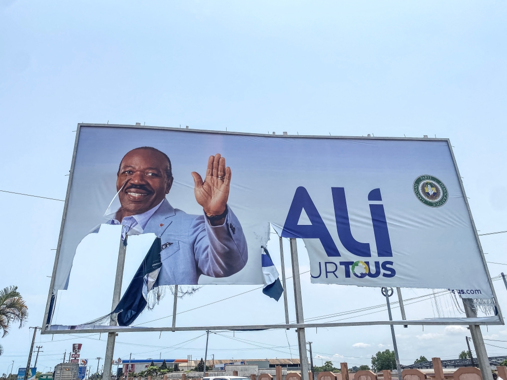 A general view of a torn campaign billboard of ousted Gabon President Ali Bongo Ondimba in Libreville on August 31, 2023.  (Photo by AFP)