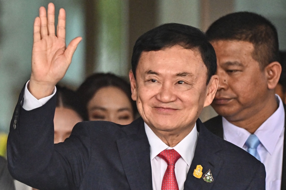 File photo: Former Thai Prime Minister Thaksin Shinawatra greets his supporters after landing at Bangkok's Don Mueang airport on August 22, 2023. (Photo by Lillian Suwanrumpha / AFP)