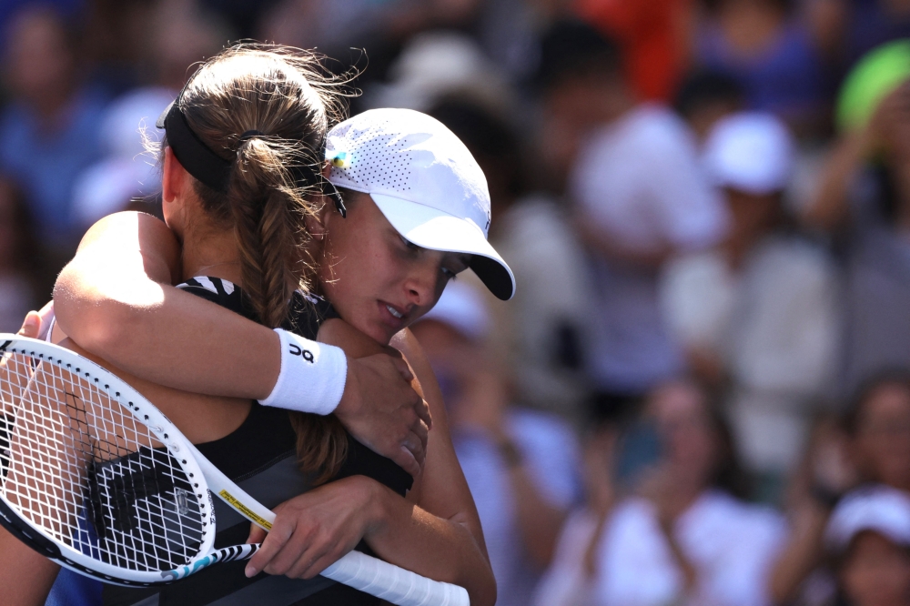 Poland's Iga Swiatek embraces her best friend defeated Slovenia's Kaja Juvan during the US Open tennis tournament women's singles third round match at the USTA Billie Jean King National Tennis Center in New York City, on September 1, 2023. (Photo by Kena Betancur / AFP)